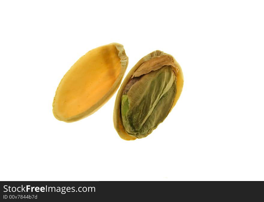 Pistachio nut with half shell removed showing green kernel