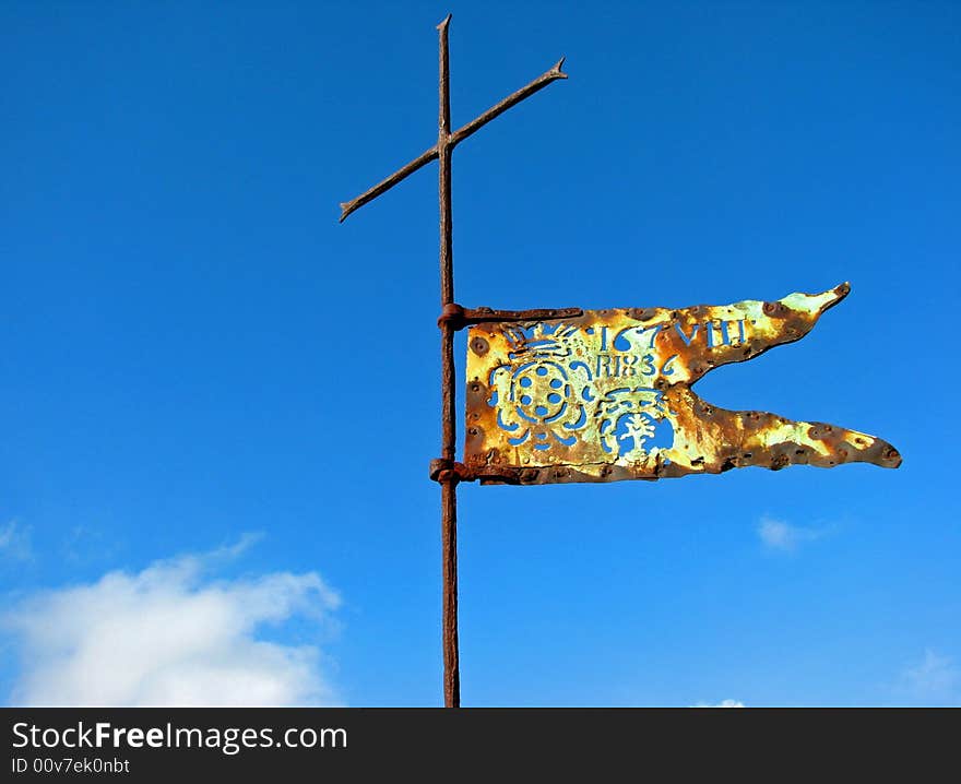 A Renaissance flag and cross atop a Tuscan castle and fortress. A Renaissance flag and cross atop a Tuscan castle and fortress.