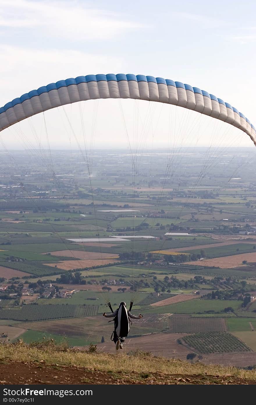 Alone over the plains while paragliding. Alone over the plains while paragliding