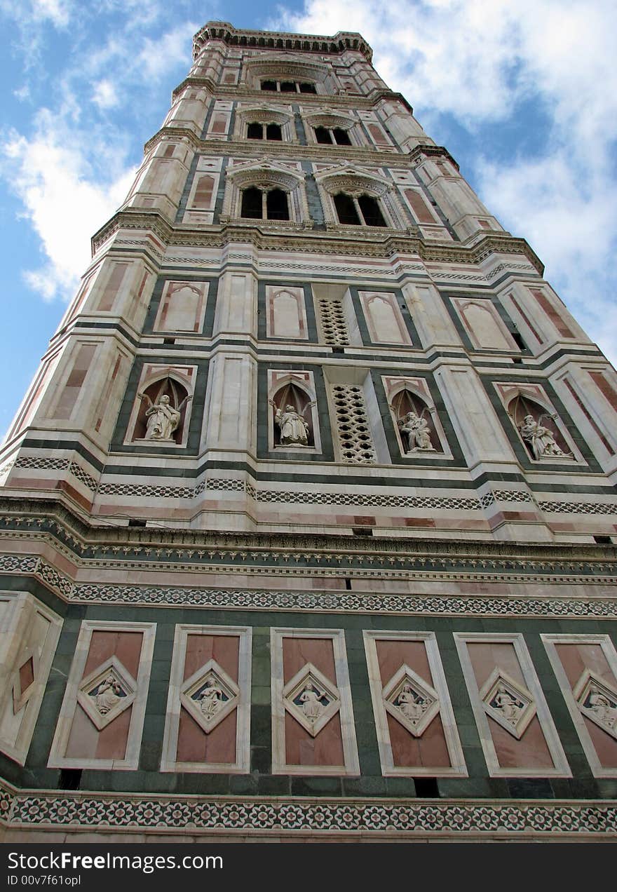 A view from the street level looking directly up the bell tower next to the Florence, Italy Duomo. The campanile (tower) was designed by the architect Giotto. A view from the street level looking directly up the bell tower next to the Florence, Italy Duomo. The campanile (tower) was designed by the architect Giotto.