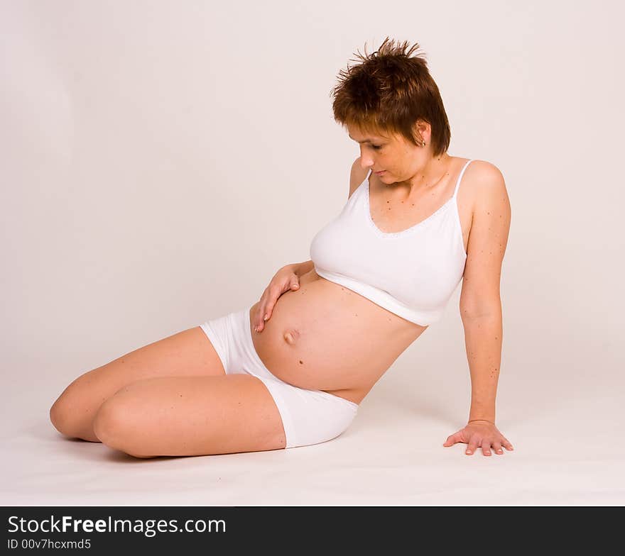 A pregnant woman showing showing her belly