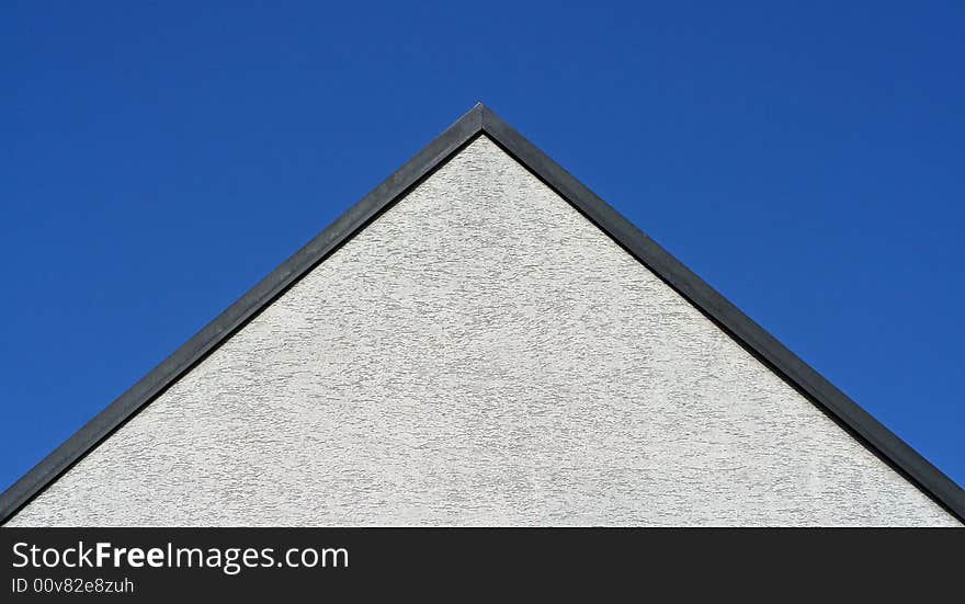 A roof and blue sky. A roof and blue sky