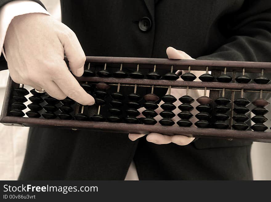 Business Hand Using A Chinese Abacus