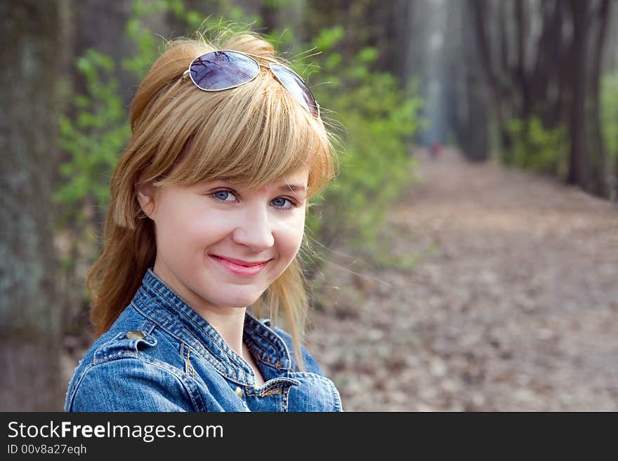 Portrait of the beautiful girl on a background of wood avenue. Portrait of the beautiful girl on a background of wood avenue.