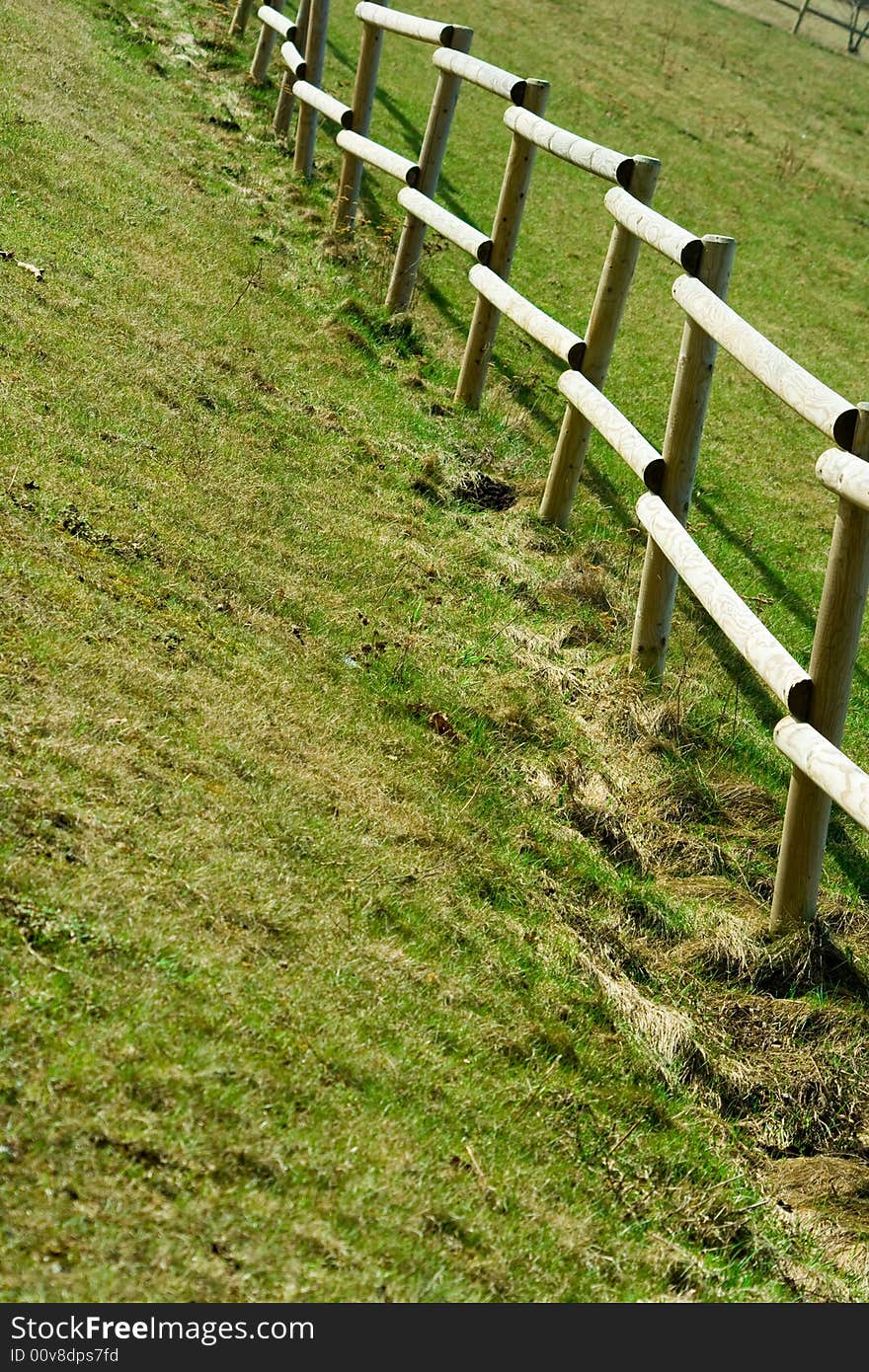 Wooden fence on the country grass