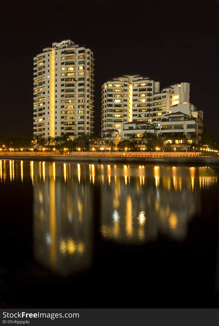 Modern Towers are reflected in a still river near the sea. Modern Towers are reflected in a still river near the sea.