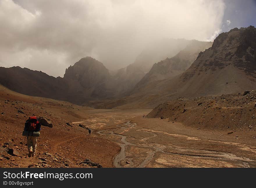 Three mountaineers trek toward the base camp of one of the worlds highest mountains. Three mountaineers trek toward the base camp of one of the worlds highest mountains.