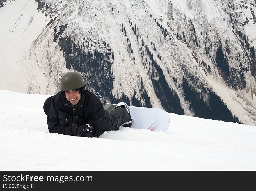 Smiling man on board in mountains over snow. Smiling man on board in mountains over snow