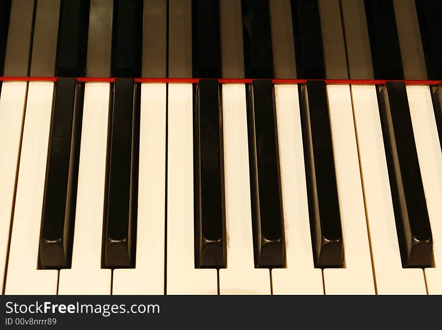 The keyboard of a piano with reflection