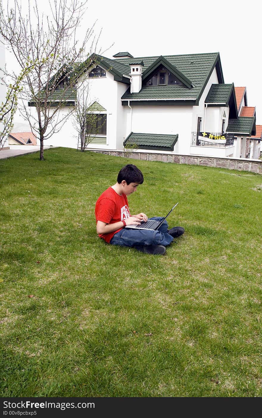 Young man pressing a key on a laptopkeyboard. Young man pressing a key on a laptopkeyboard