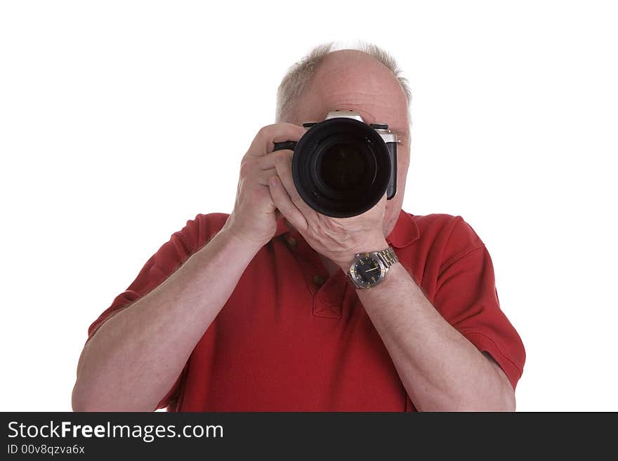 A man with an SLR camera and a zoom lens pointing at the camera. A man with an SLR camera and a zoom lens pointing at the camera