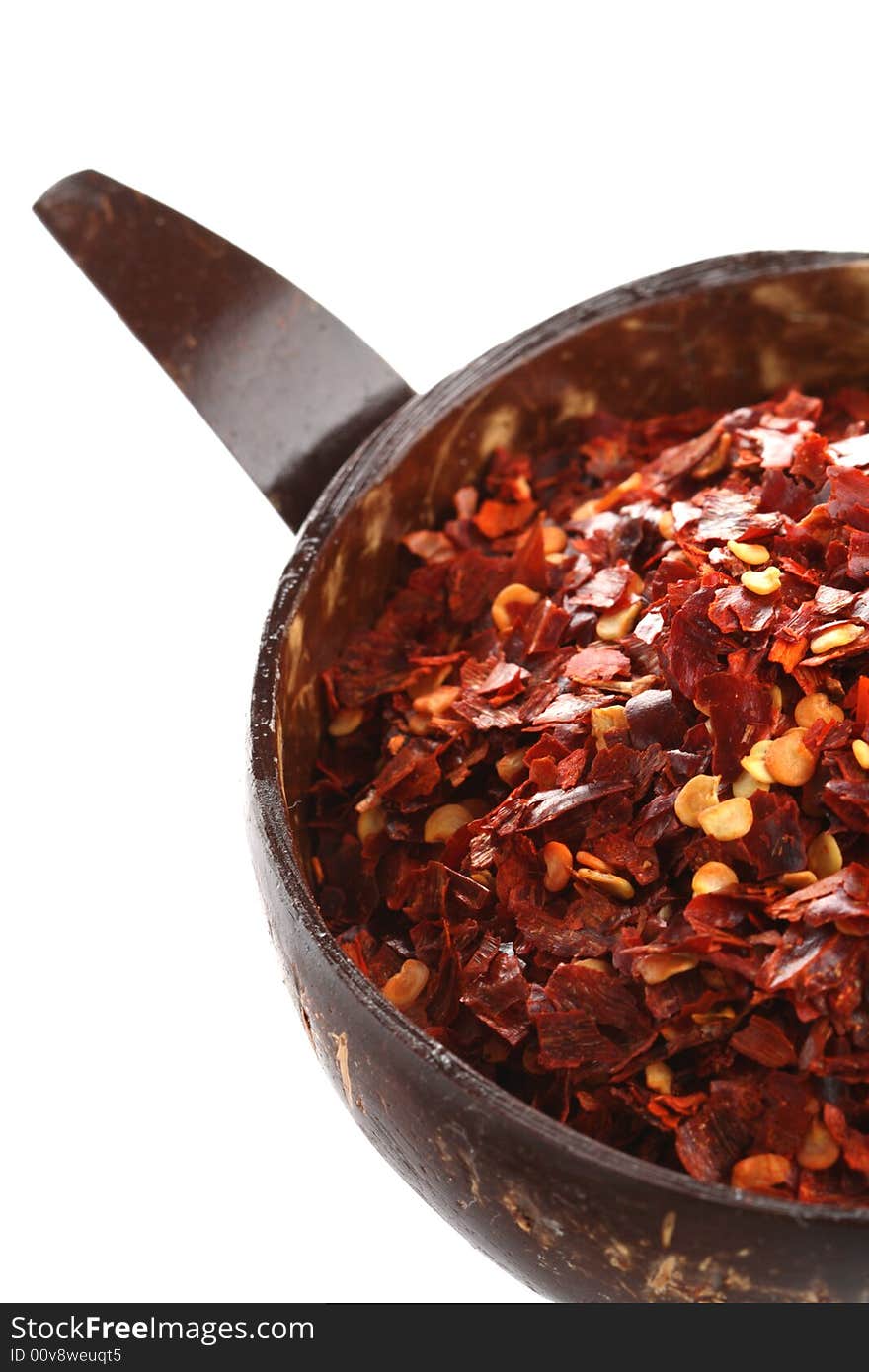 Hot Red Chilli Chillies pepper crushed, in coconut bowl, isolated on white, shallow DOF. Hot Red Chilli Chillies pepper crushed, in coconut bowl, isolated on white, shallow DOF