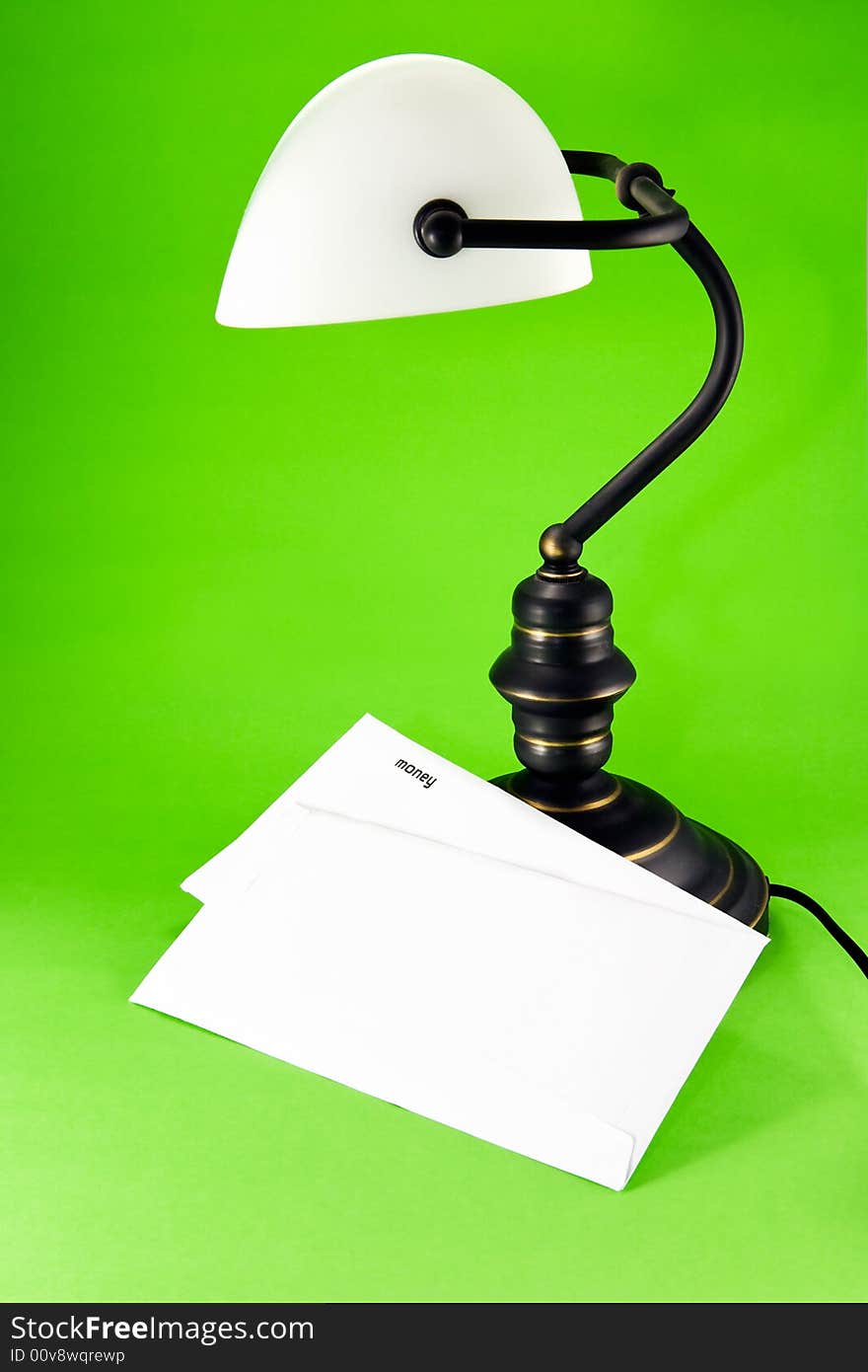 Lamp on green background, with money letter. Lamp on green background, with money letter