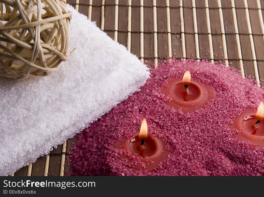 Towel and candles on mat in spa style