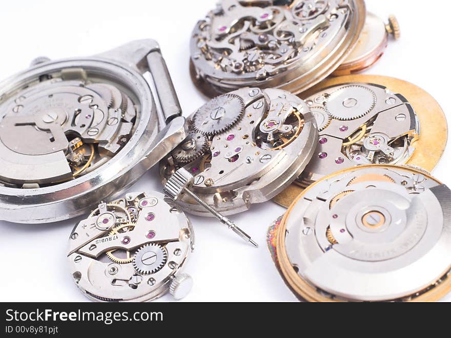 Bunch of old clock mechanisms on white background. Bunch of old clock mechanisms on white background