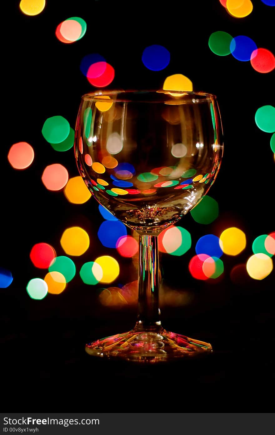 Wine glass with colored light spots. Wine glass with colored light spots