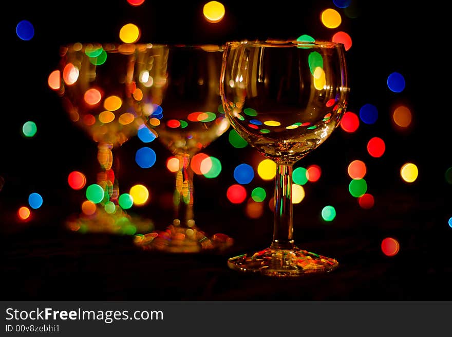 Three wine glasses in perspective with colored spots. Three wine glasses in perspective with colored spots