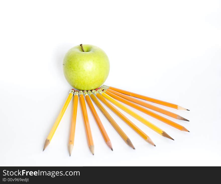 Pencils and apple