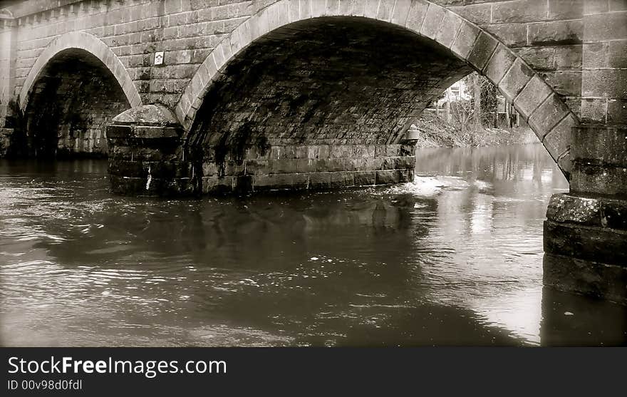 Fresh water rushes under the archway of a bridge in Ireland. Fresh water rushes under the archway of a bridge in Ireland