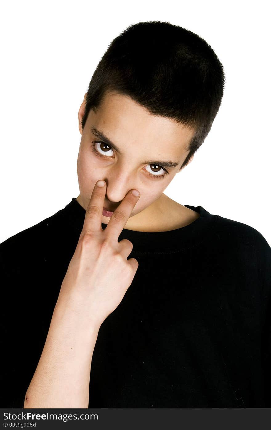 Young teenage boy pointing to his eyes