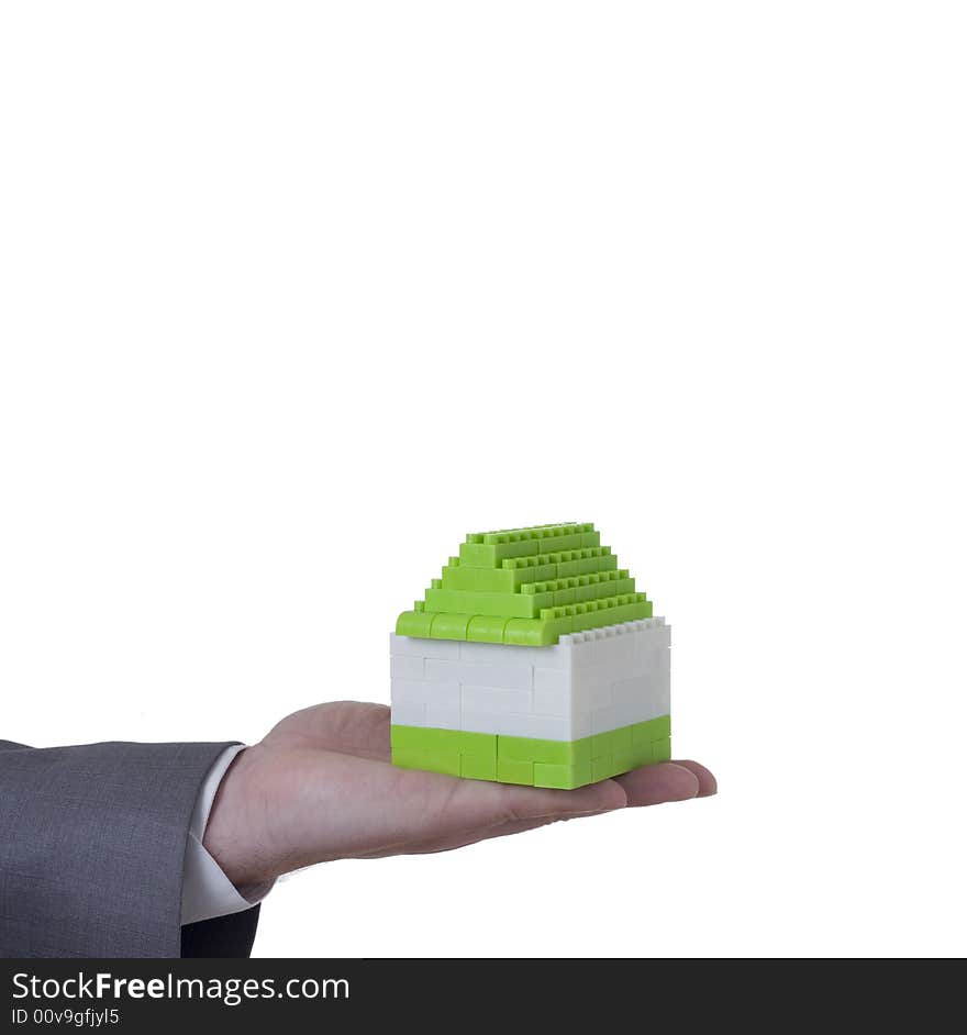 Hand of businessman holding small house