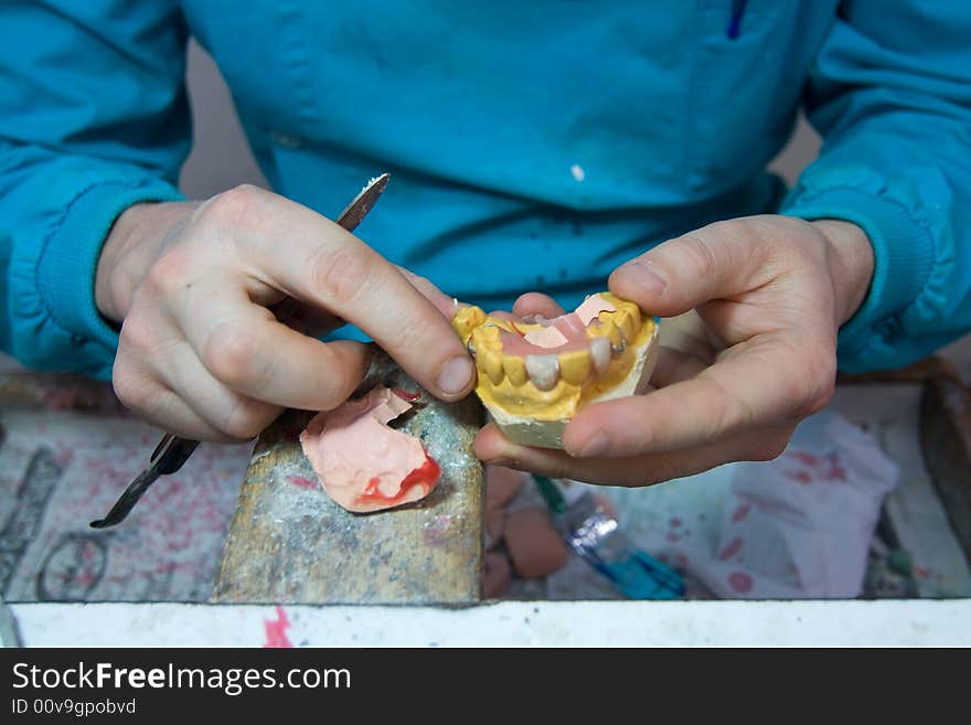 Dental technician while doing his job. Dental technician while doing his job