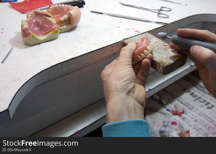 Dental technician while doing his job. Dental technician while doing his job