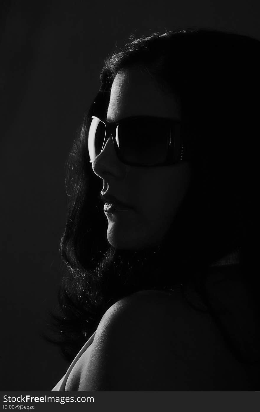 Black and white portrait of young woman wearing sunglasses. Black and white portrait of young woman wearing sunglasses