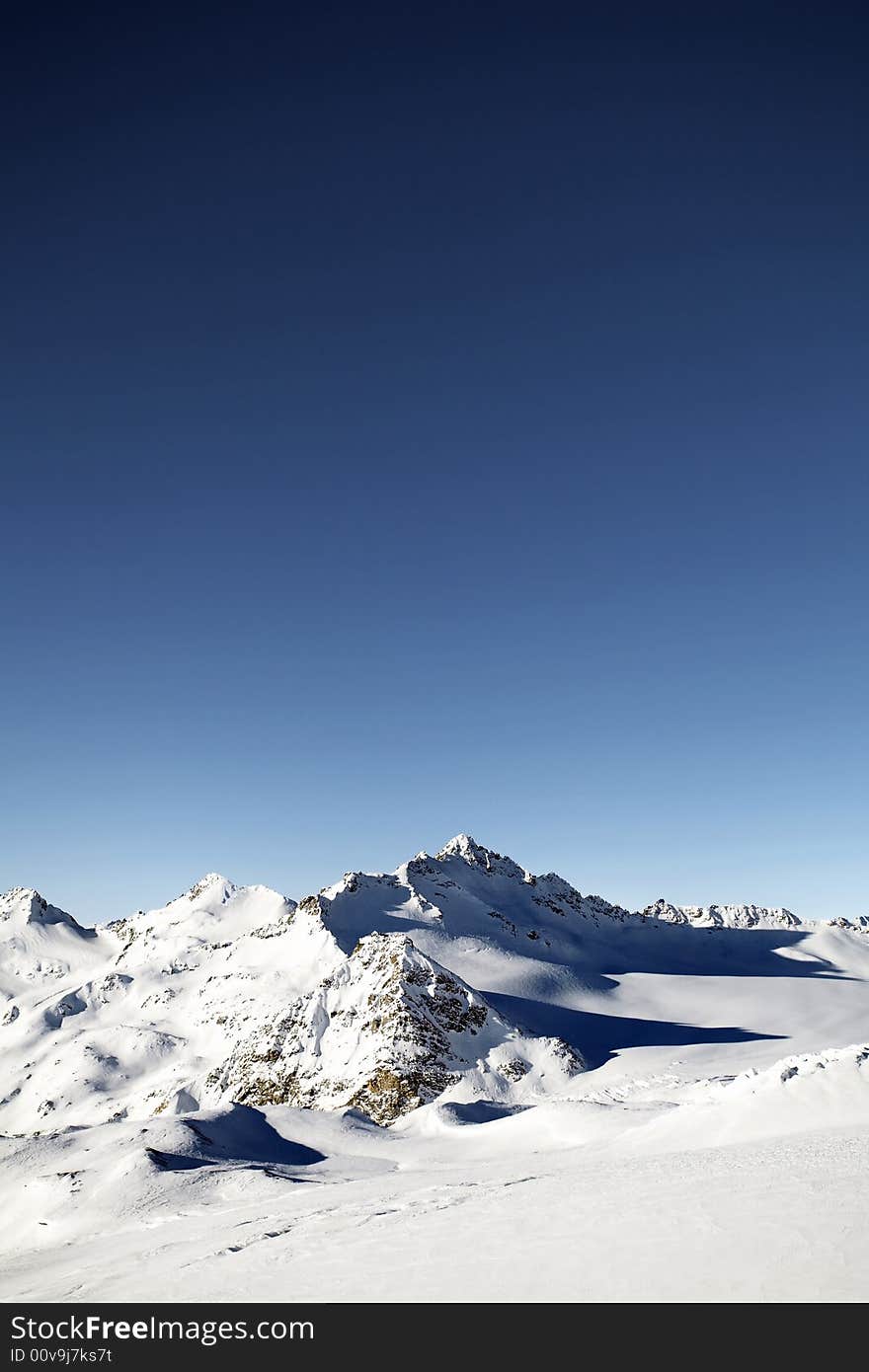 Winter mountain peaks and a lot of snow. Winter mountain peaks and a lot of snow