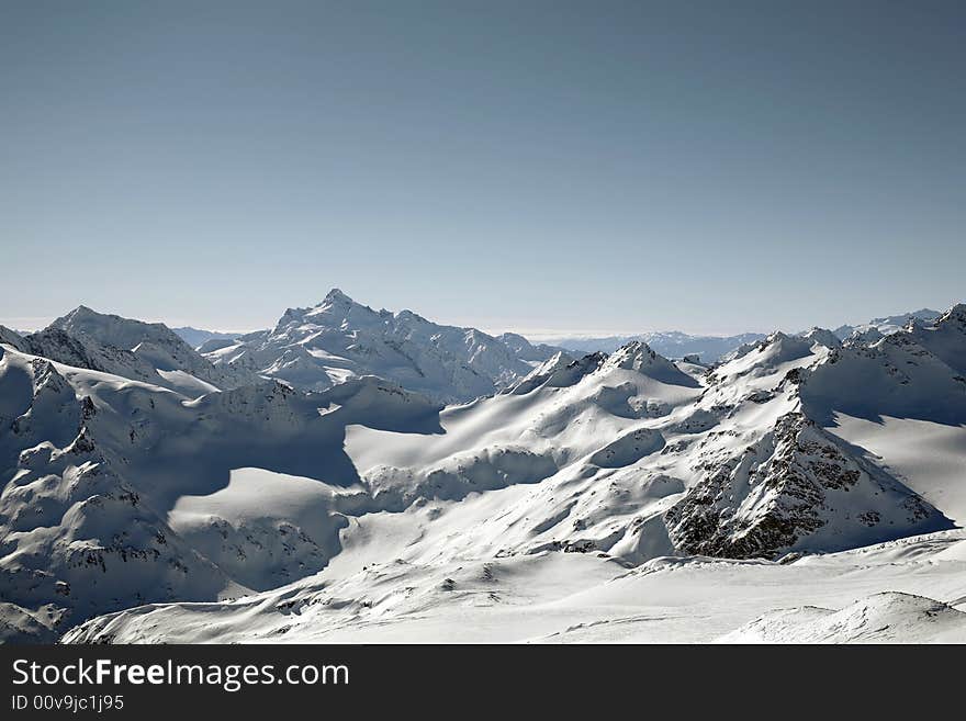 Winter mountain peaks and a lot of snow. Winter mountain peaks and a lot of snow