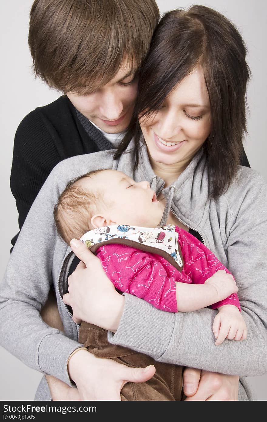 Happy young family - father, mother and their cute little baby. Happy young family - father, mother and their cute little baby