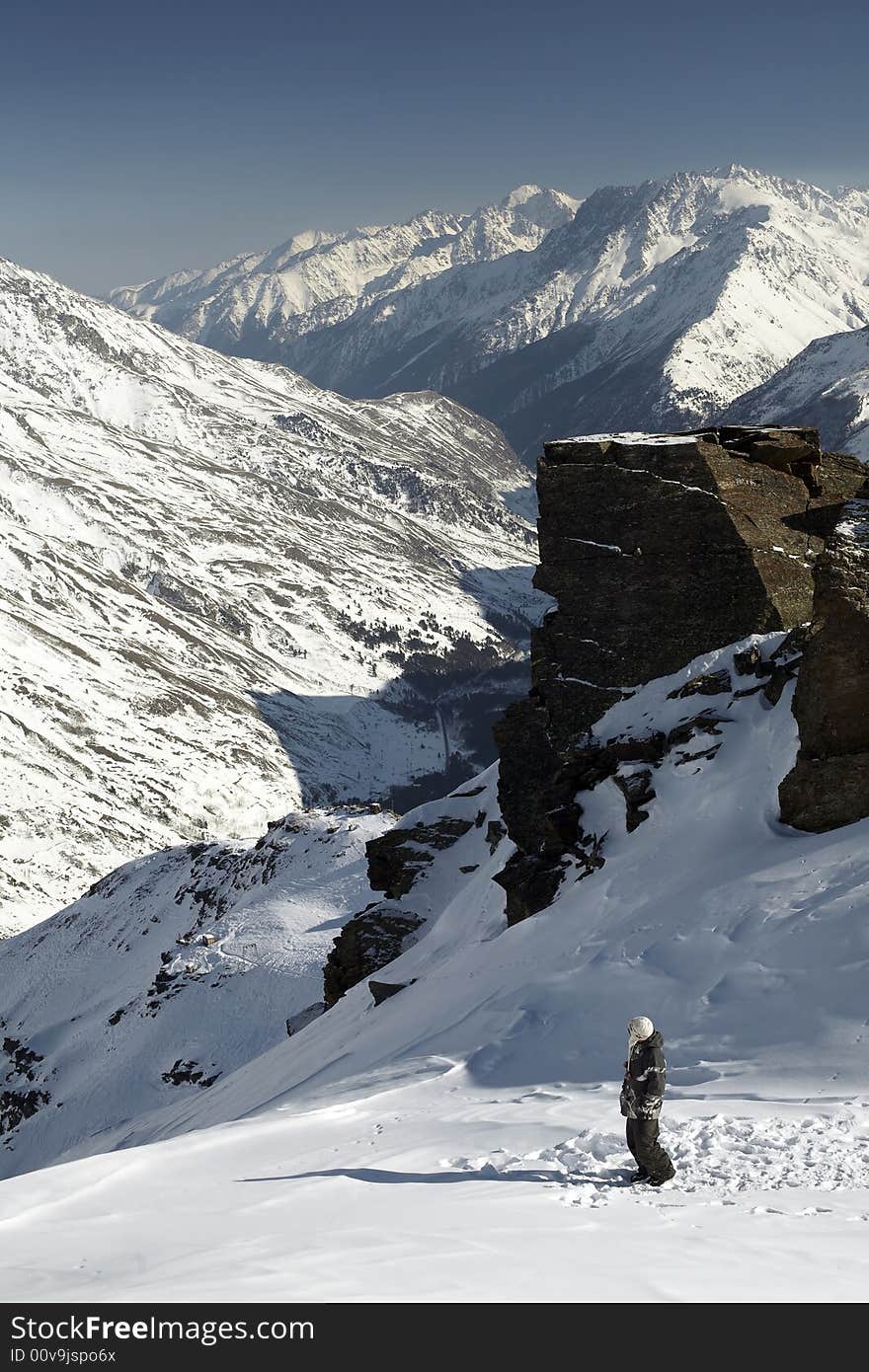 Standing snowboarder, high mountains and a lot of snow. Standing snowboarder, high mountains and a lot of snow