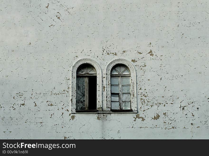 Two vintage windows and curious texturized wall.