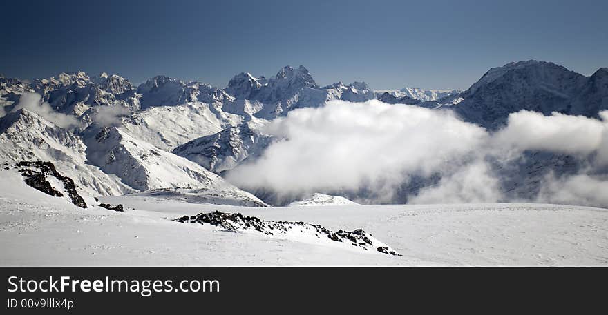 Winter mountain peaks and a lot of snow. Winter mountain peaks and a lot of snow