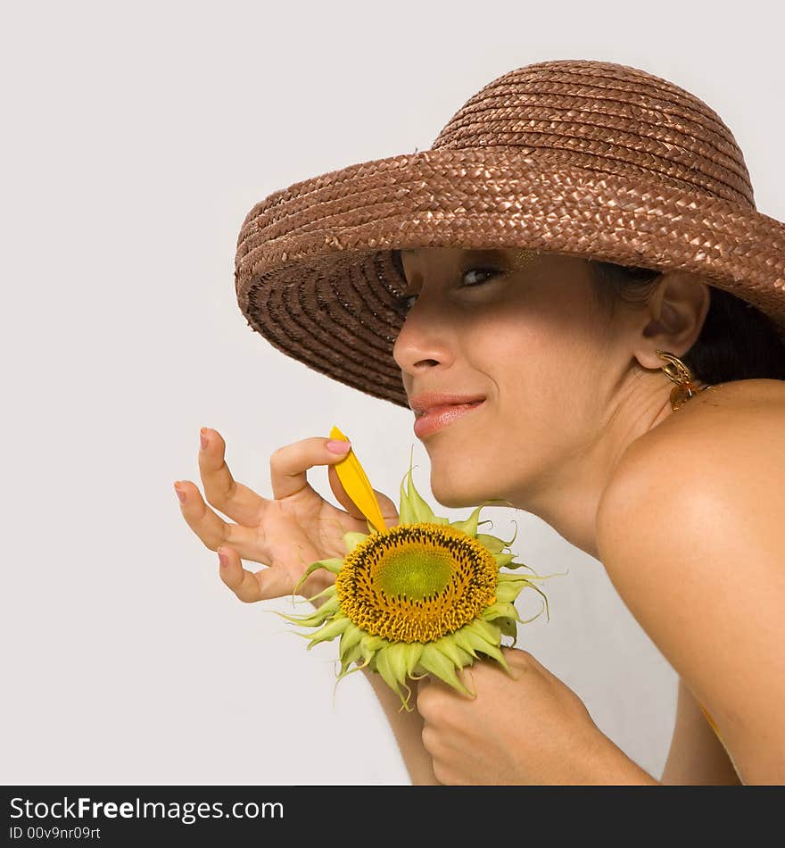 Girl holding last sunflower petal with happy expression. Girl holding last sunflower petal with happy expression