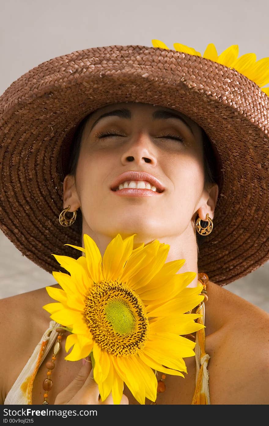 Portrait of young hispanic woman holding sunflower. Portrait of young hispanic woman holding sunflower