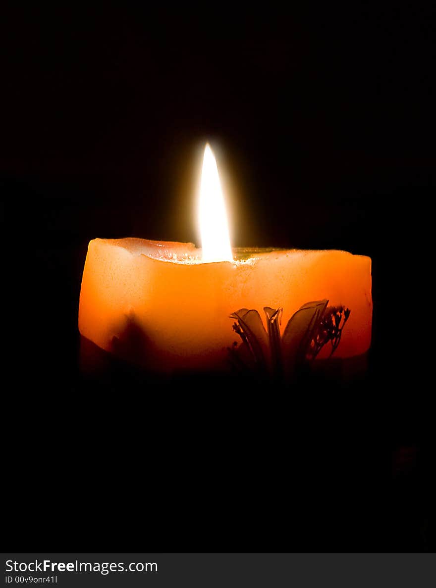 Ornamental candle on black background