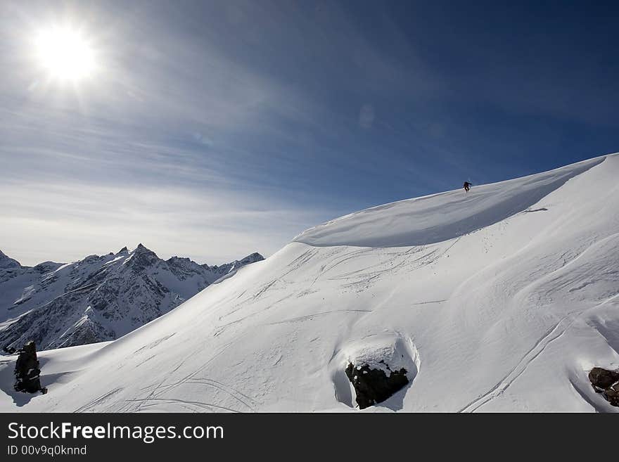 Ski freeride in high mountains, sky, winter