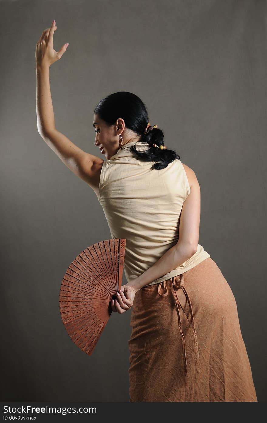 Portrait of hispanic flamenco dancer in traditional pose with fan. Portrait of hispanic flamenco dancer in traditional pose with fan