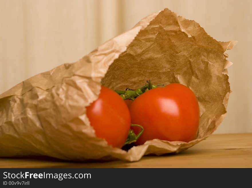 Tomato in brown paper bag