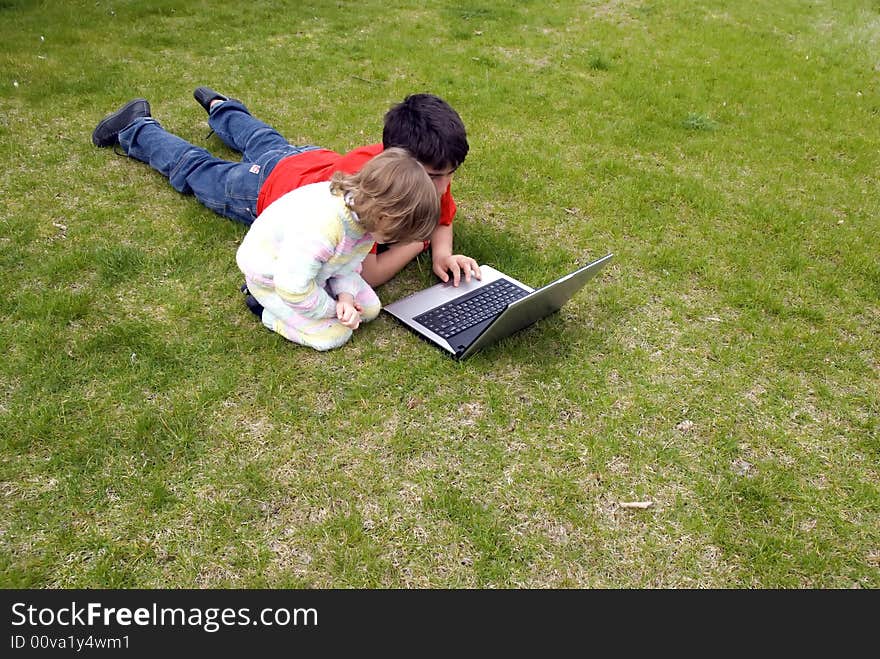 Boy and the girl with the laptop,in the garden. Boy and the girl with the laptop,in the garden