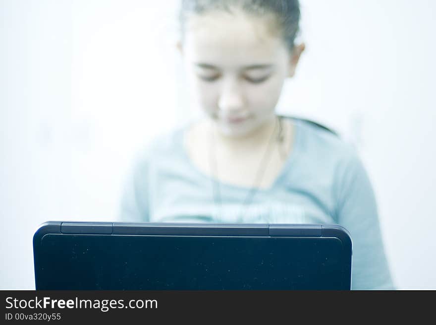 Teen working on laptop computer