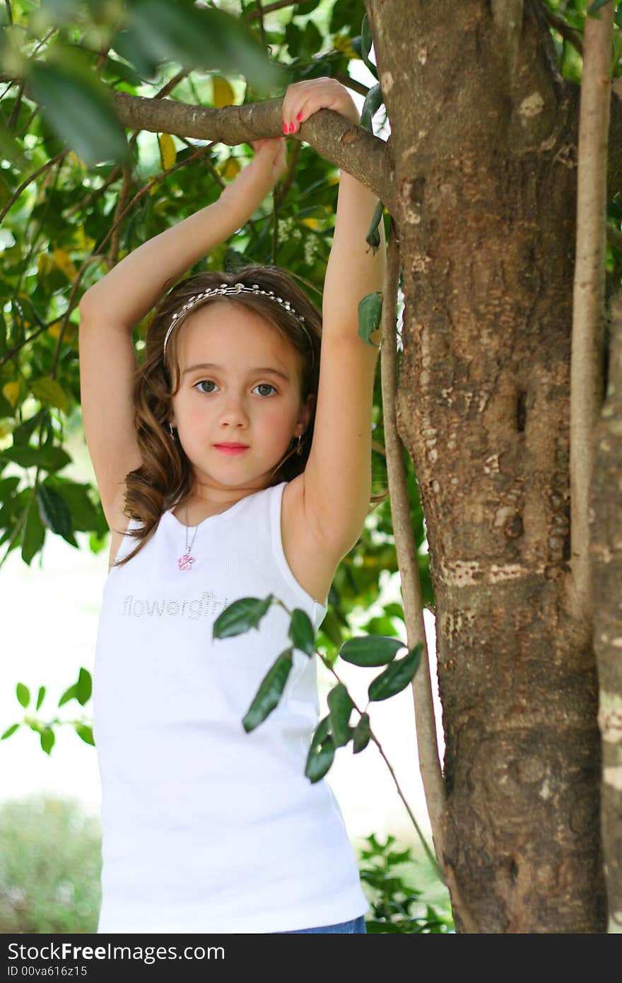 Brown hair girl under a tree. Brown hair girl under a tree