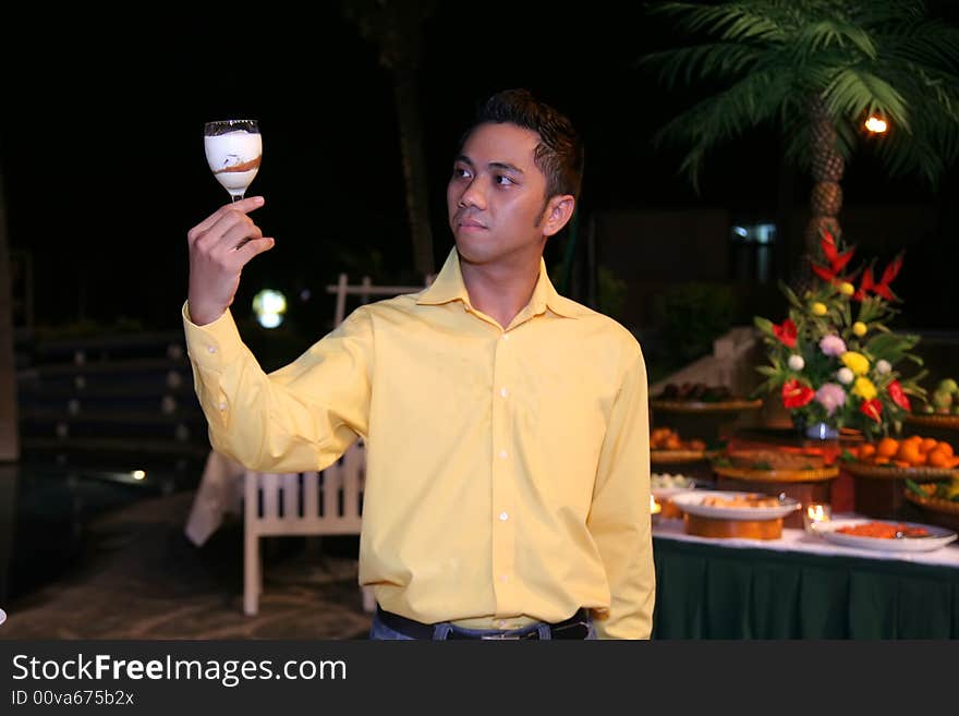 Man or waiter holding glass with food in it at outdoor dinner buffet