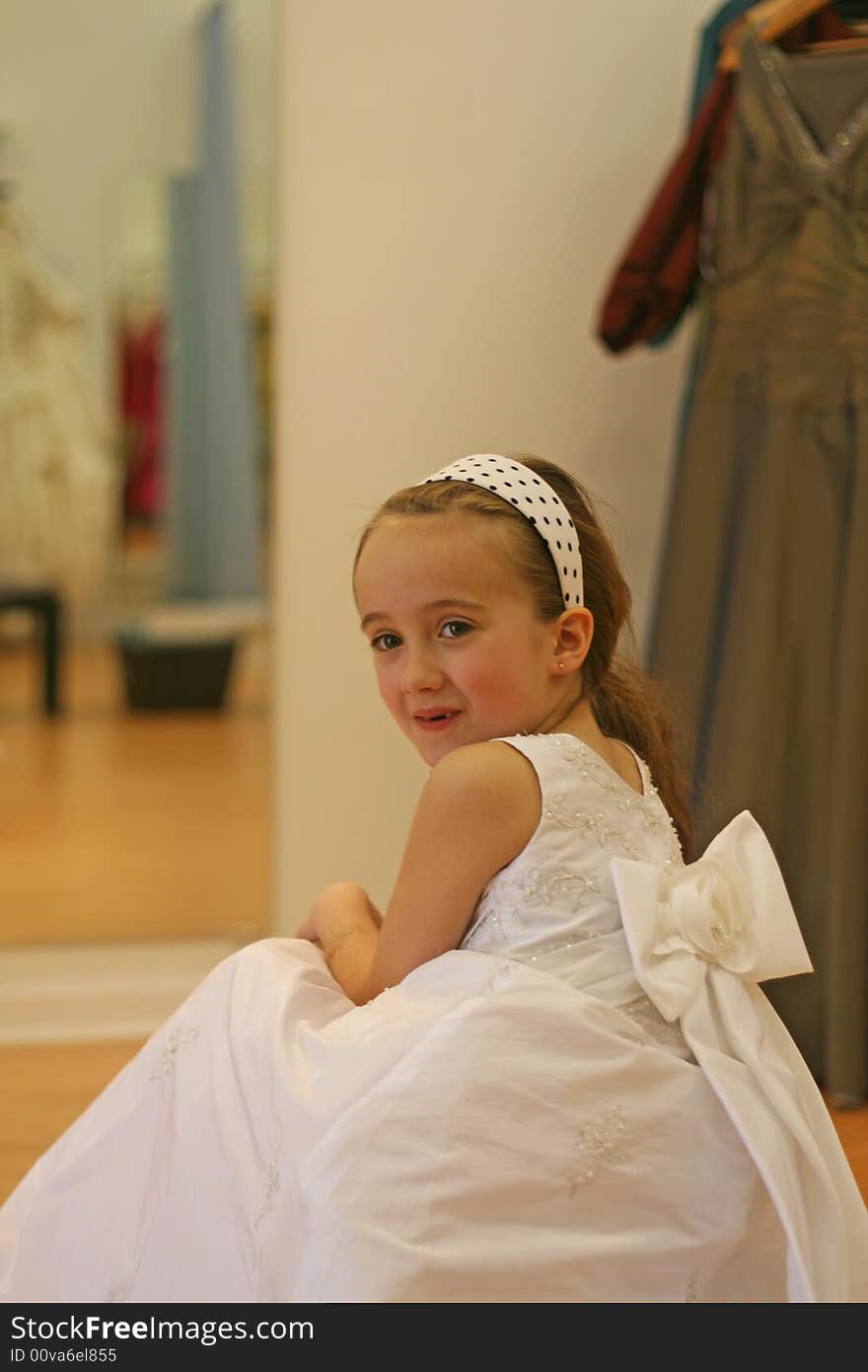 Brown hair girl trying on her dress. Brown hair girl trying on her dress