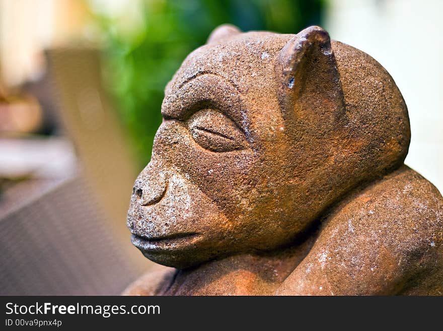 A sleeping stone monkey sculpture