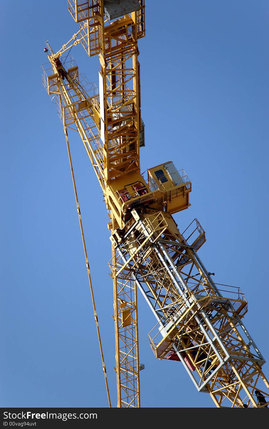 Lifting crane building the house on a blue sky