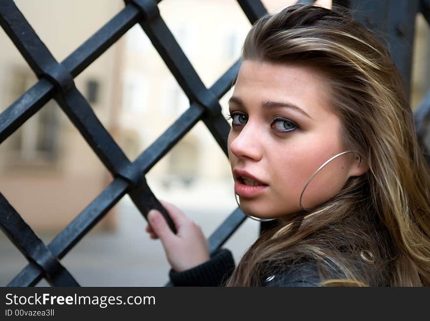 The young girl at gate. The young girl at gate