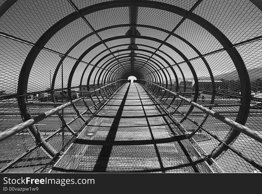 Footbridge over highway with arcs, black and white image. Footbridge over highway with arcs, black and white image