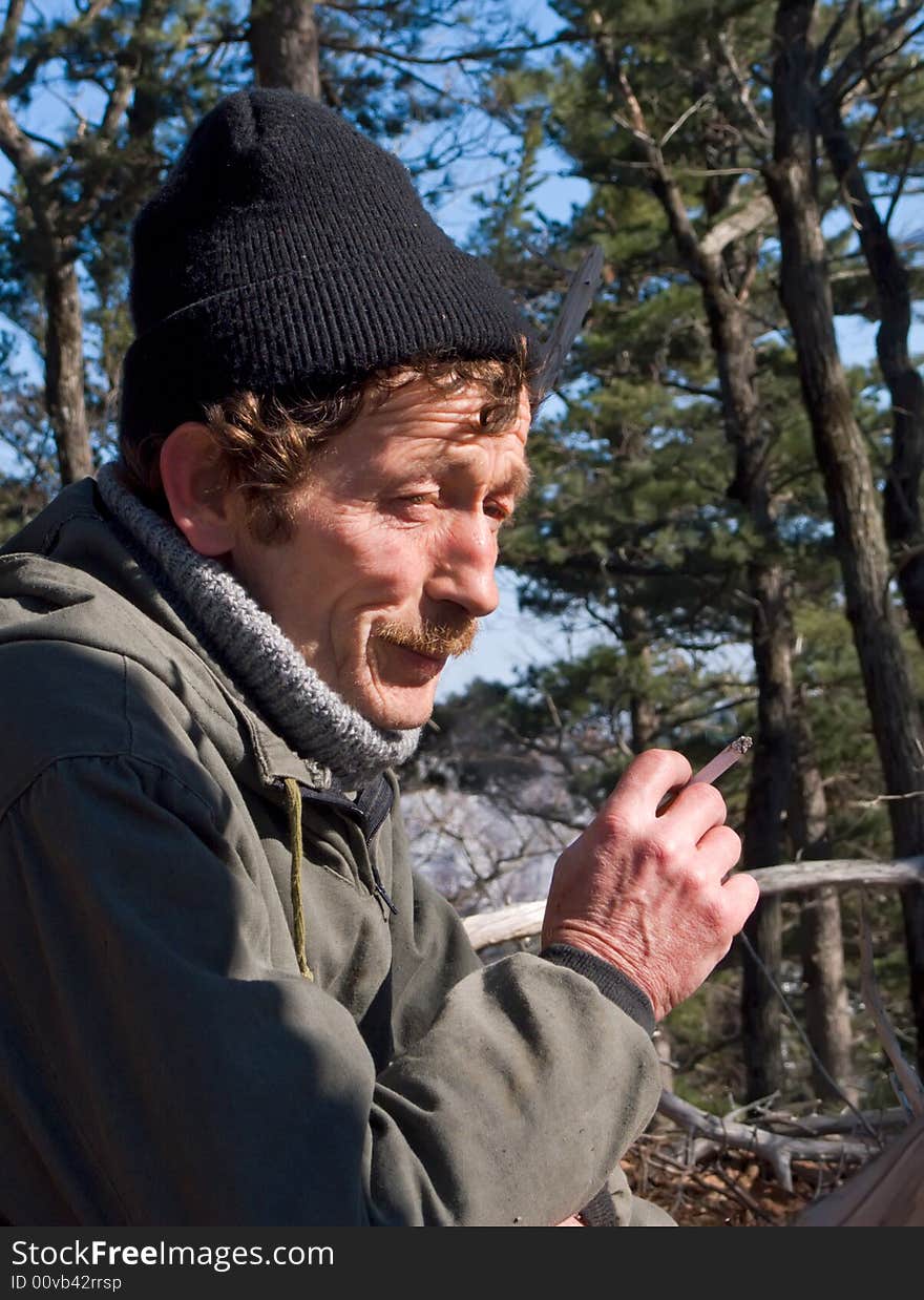 A portrait of a smoking men with stocking cap on his head. Russian Far East, Primorye. A portrait of a smoking men with stocking cap on his head. Russian Far East, Primorye.